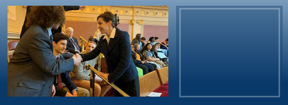 Senator Jill Vogel shaking hands with a man in an auditorium