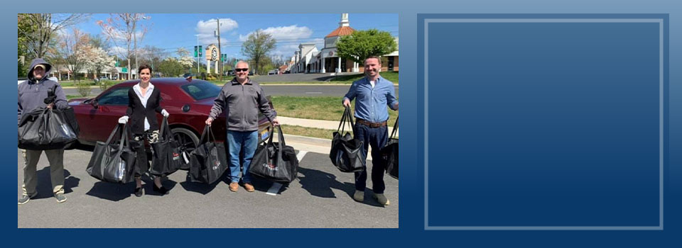 Senator Jill Vogel standing with men delivering goods